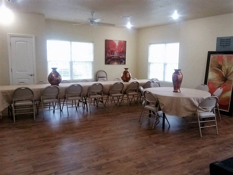 a room with tables and chairs and vases in it
