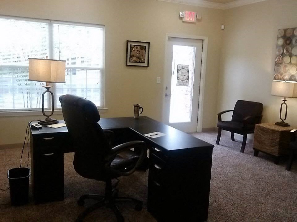 a home office with a desk and a chair