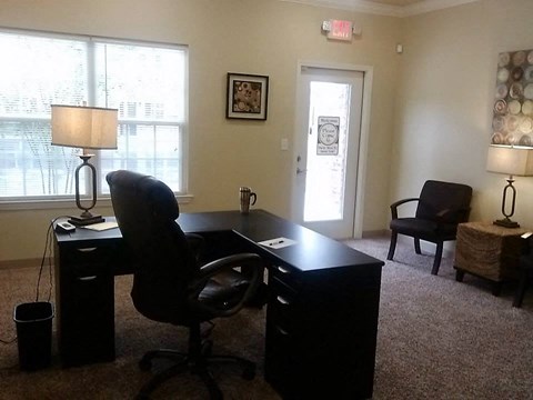 a home office with a desk and a chair