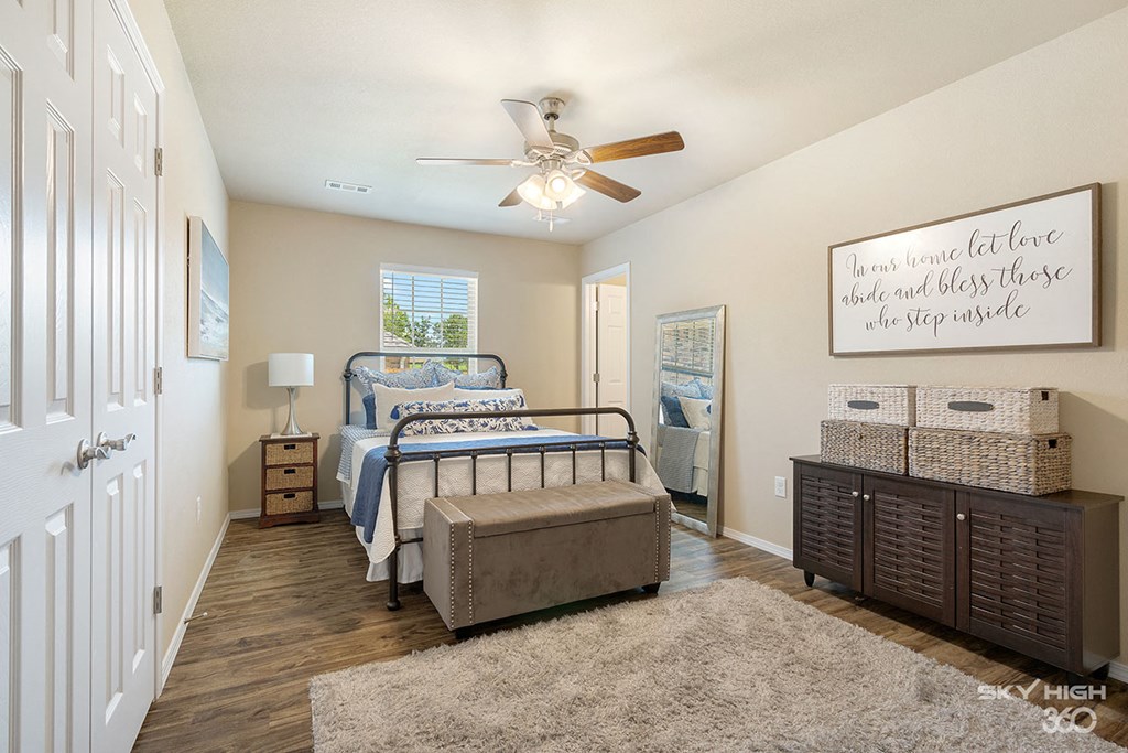 a bedroom with a bed and a ceiling fan