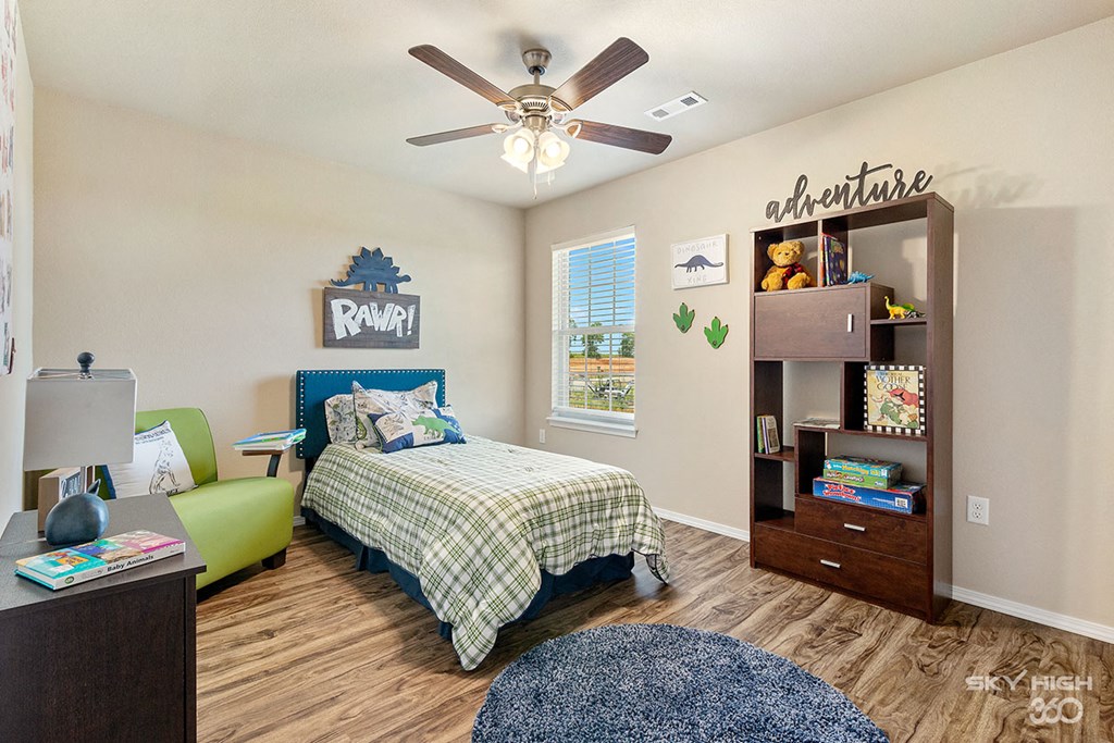 a bedroom with a bed and a ceiling fan