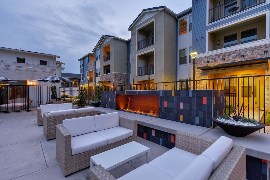 Outdoor Seating  in Pool Area, Fireplace, Gates, and Cushioned Seating at Morgan Ranch Apartments, Morgan Hill, 95037