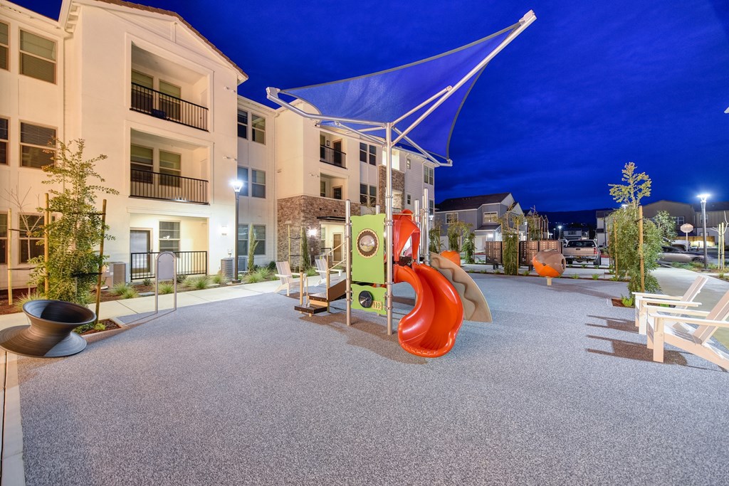 Playground area at night with bright blue skies at Morgan Ranch Apartments, Morgan Hill