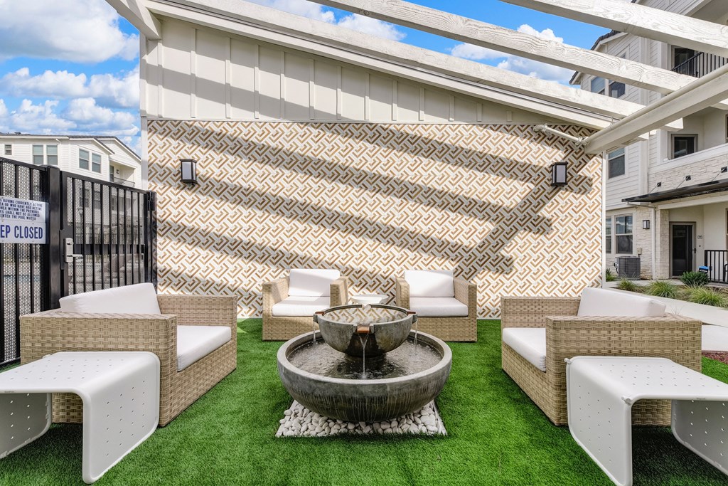 Sitting area with fountain in the center of the seating and Grass at Morgan Ranch Apartments, Morgan Hill, CA, 95037