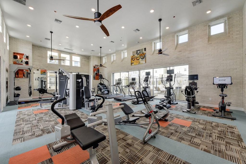 Fitness Center with Excercise Bikes, Ellipticals, Ceiling Fan and Patterned Rug at Morgan Ranch Apartments, California, 95037
