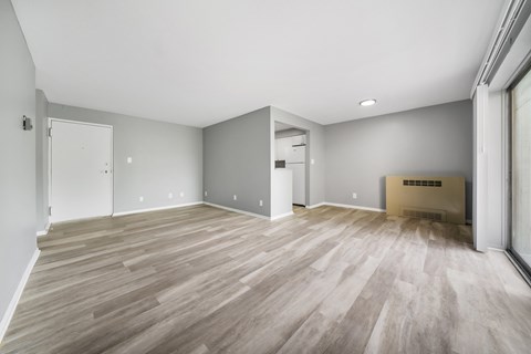the living room and kitchen of a new home with wood flooring