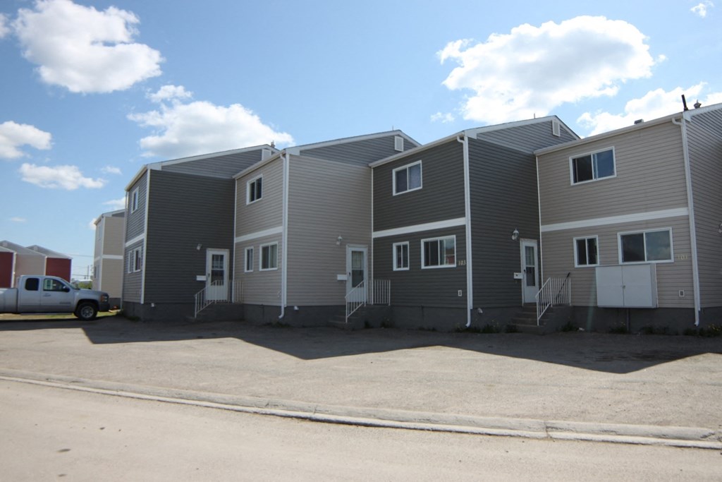 A row of houses with a truck parked in front.