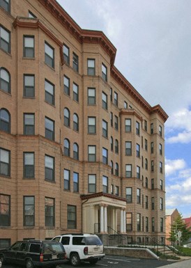 a large brick building with cars parked in front of it
