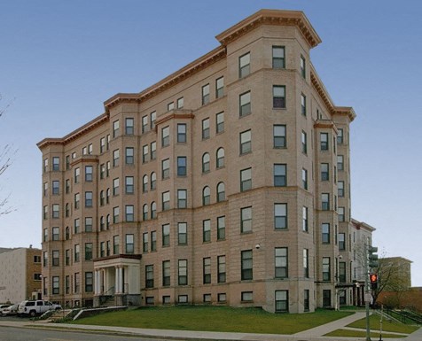 a large brick building on the corner of a street