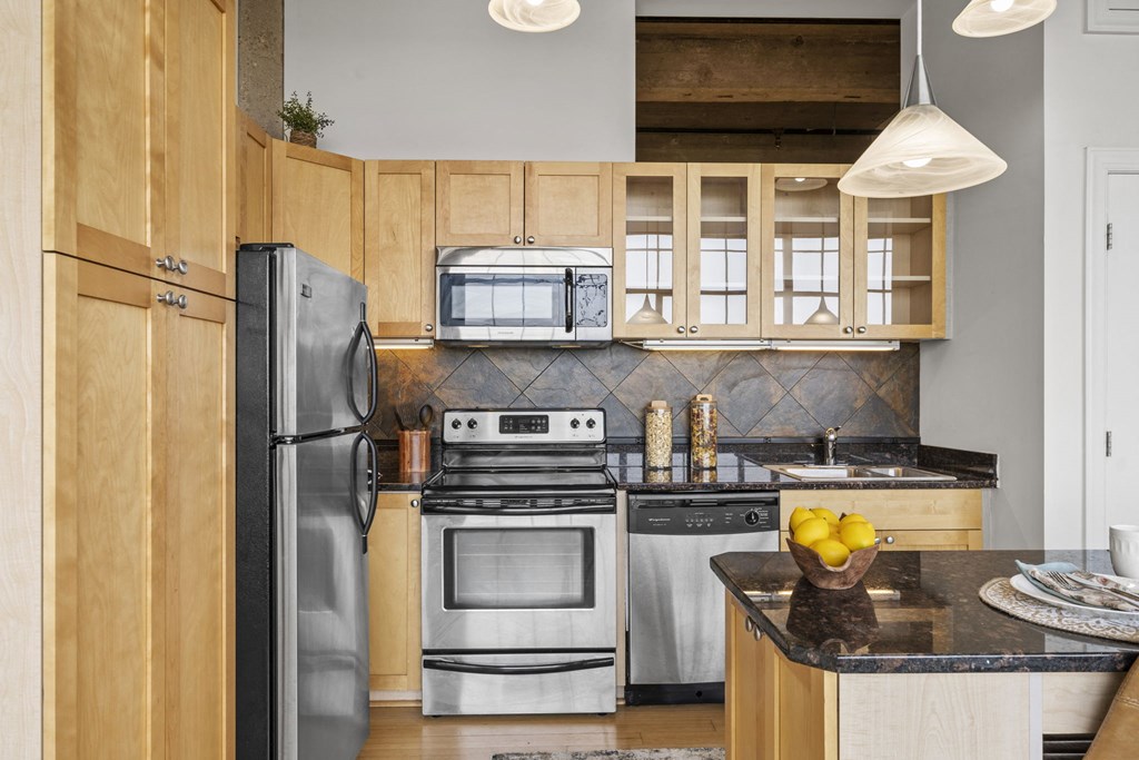 a kitchen with stainless steel appliances and wooden cabinets