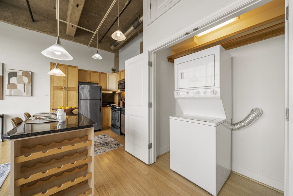 a kitchen with a washer and dryer and a white refrigerator