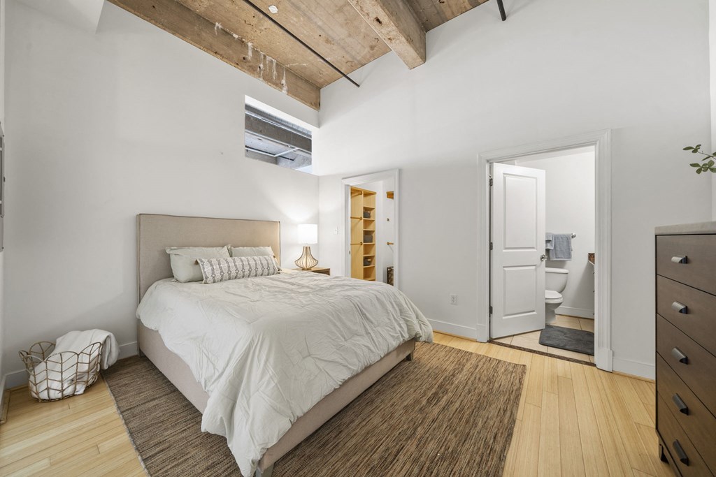 a bedroom with a bed and a wooden ceiling