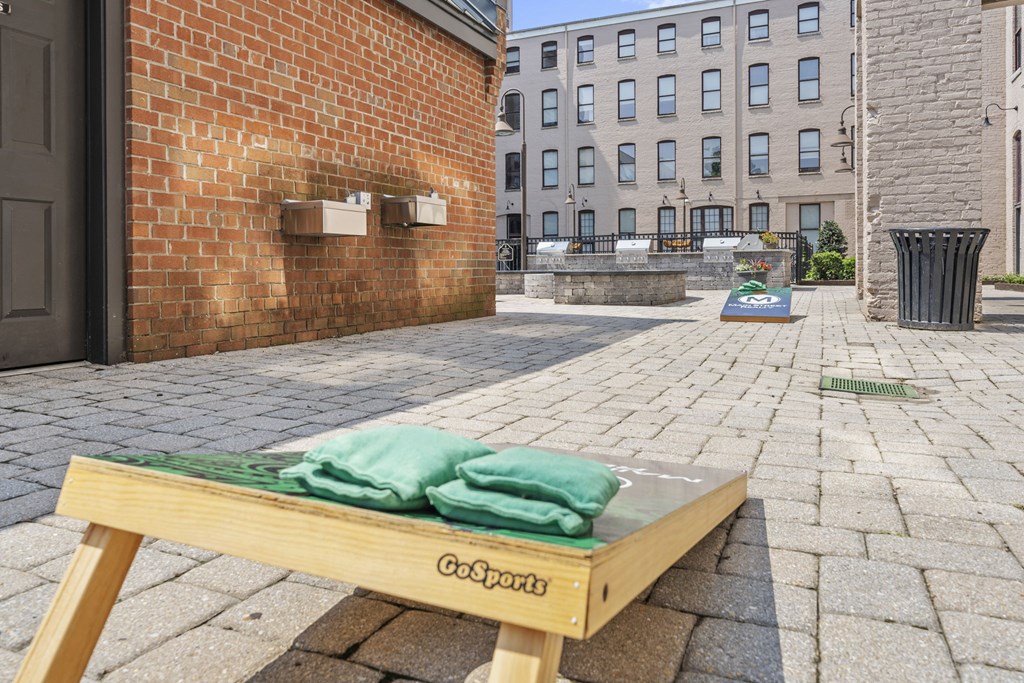 a bench with towels on it in front of a brick building