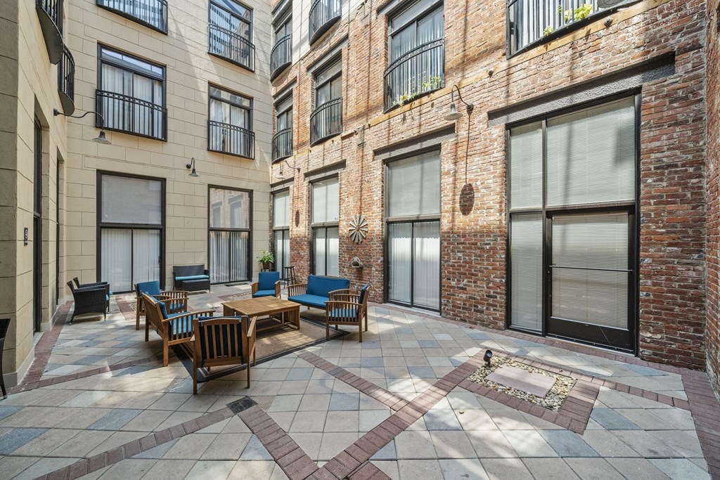 spacious courtyard with patio furniture and brick building at the adelaideelaide apartments