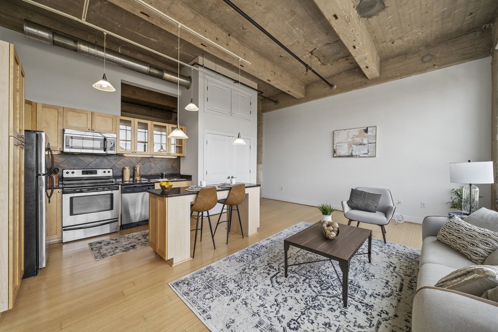 a living room with a couch and a table and a kitchen