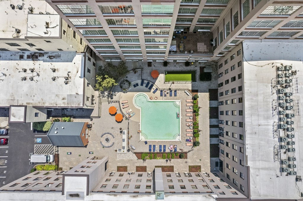 a rooftop view of a tennis court in the middle of a city