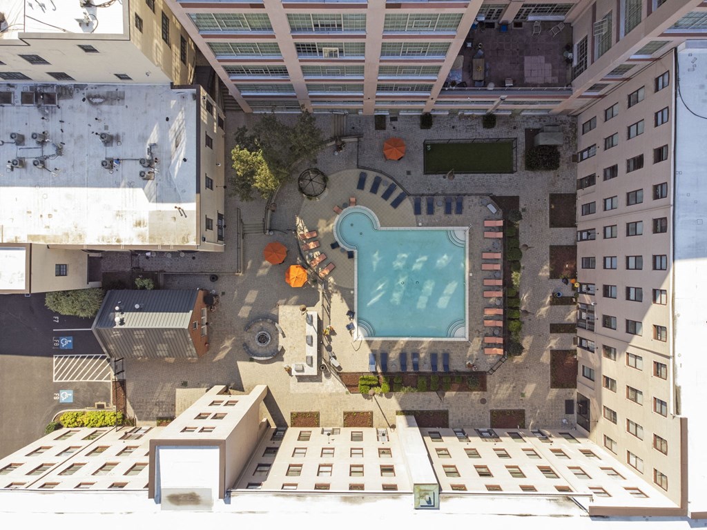 a birds eye view of a building with a pool in the middle