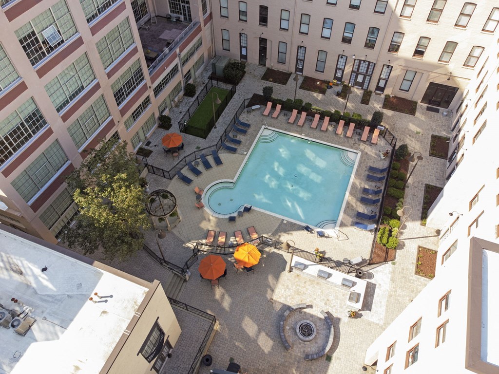 an aerial view of a swimming pool in the middle of an apartment building
