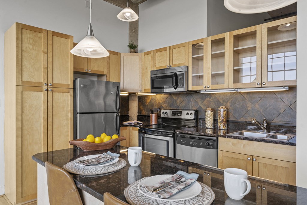 a kitchen with stainless steel appliances and wooden cabinets