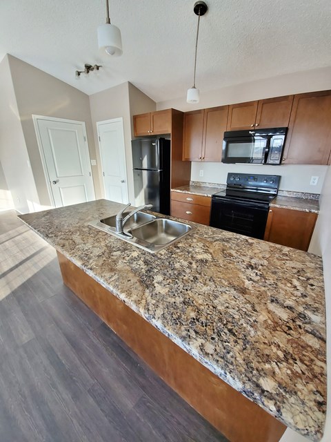 a kitchen with a granite counter top and a sink
