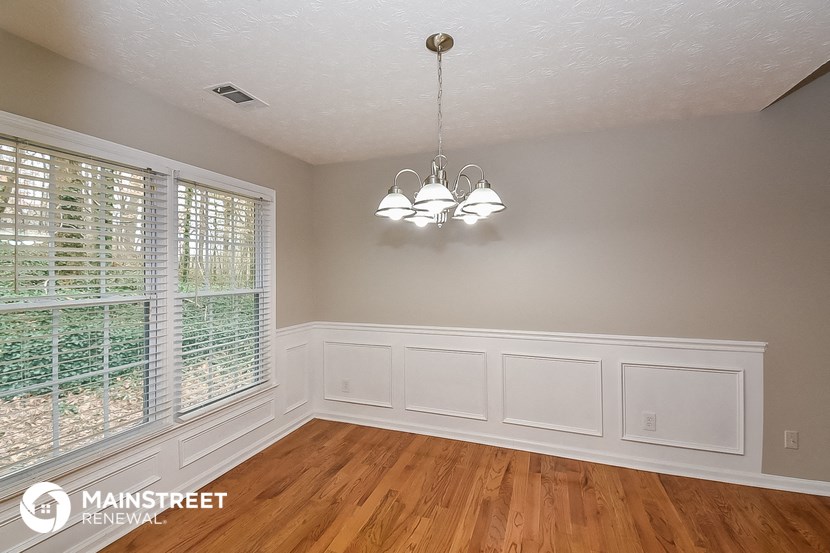 the living room after remodeling with white walls and wood floors