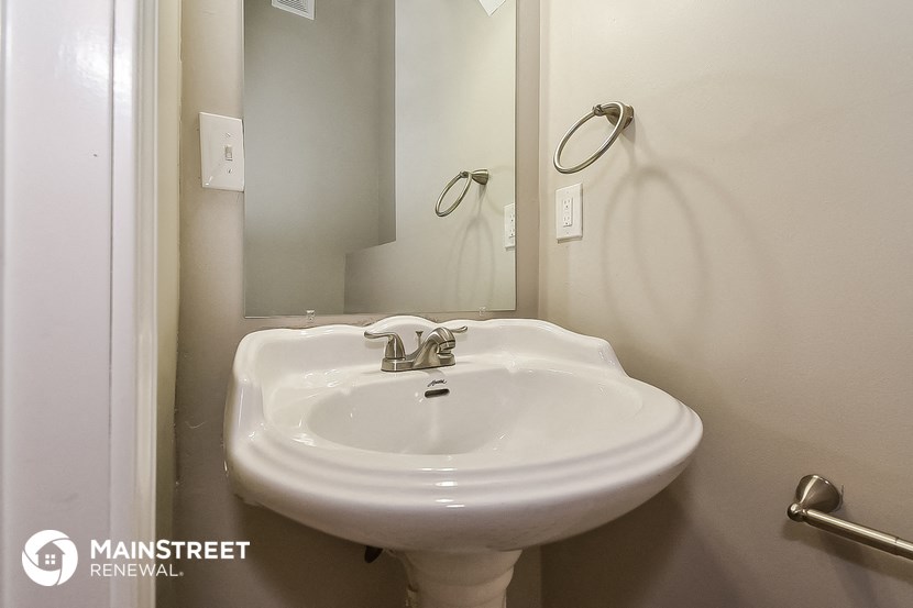 a small bathroom with a sink and a mirror