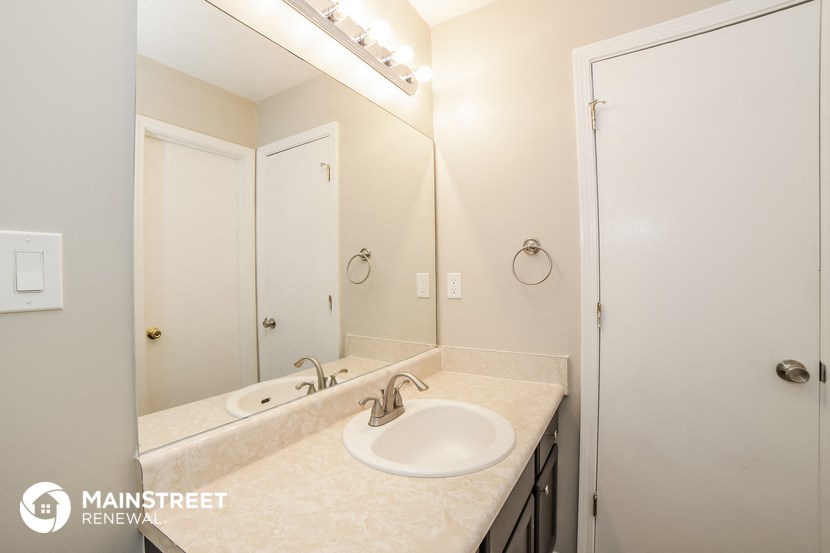 a bathroom with a sink and a mirror and a shower