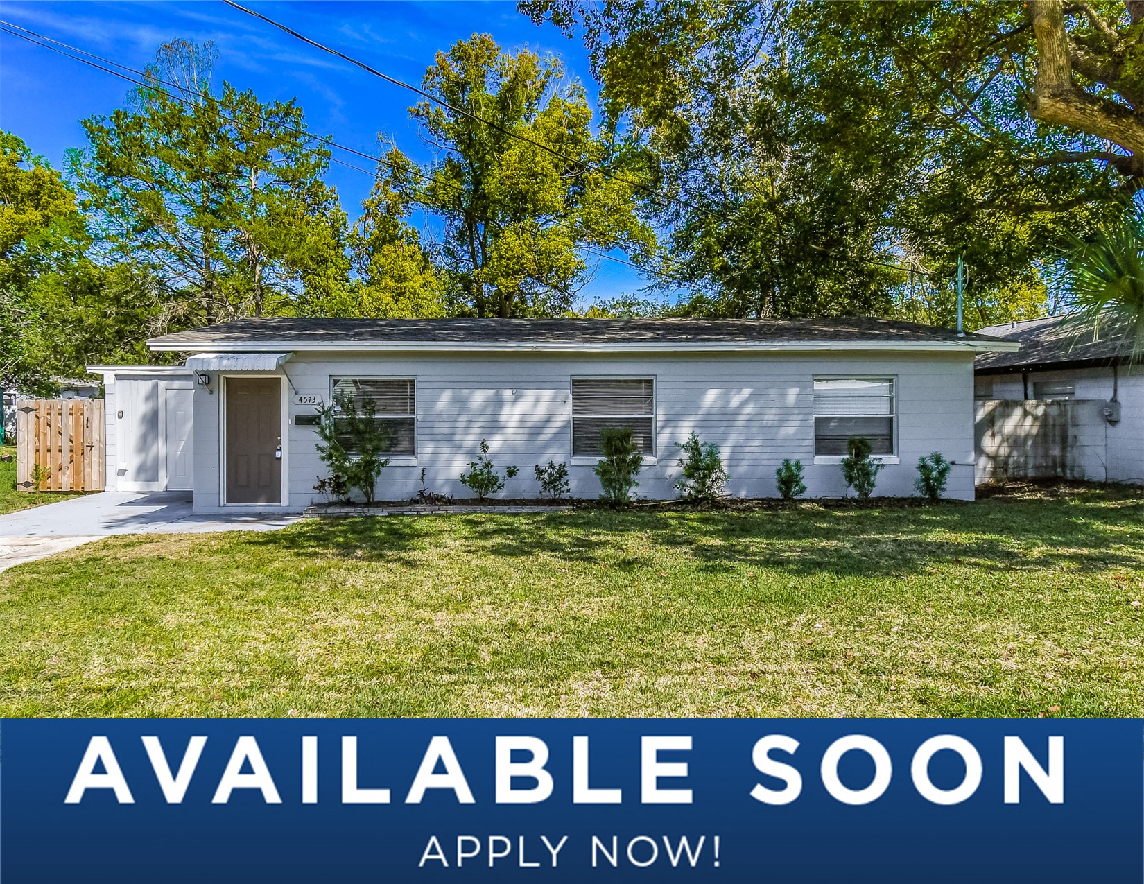 a small white house with a lawn in front of it