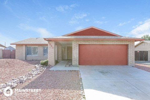 a home with a garage door in front of it