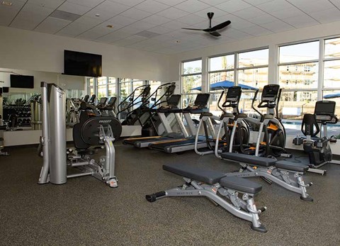 Apartments in Vacaville - Strada 1200 - A Gym Featuring A Variety of Workout Equipment and Machines with Television