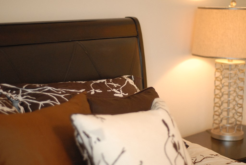 a bedroom with a bed and two lamps