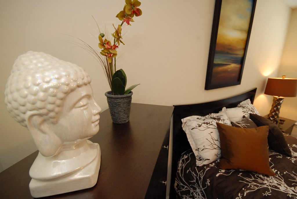 a living room with a statue of a head on a table