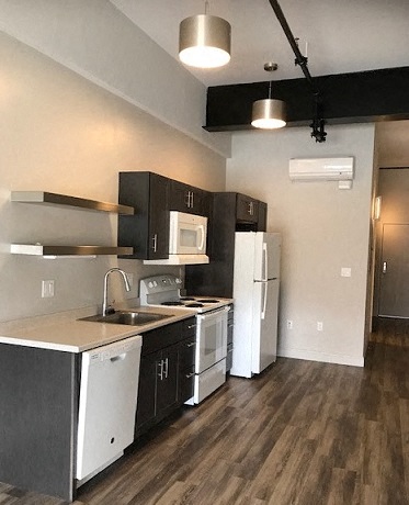 a small kitchen with a stove and a refrigerator