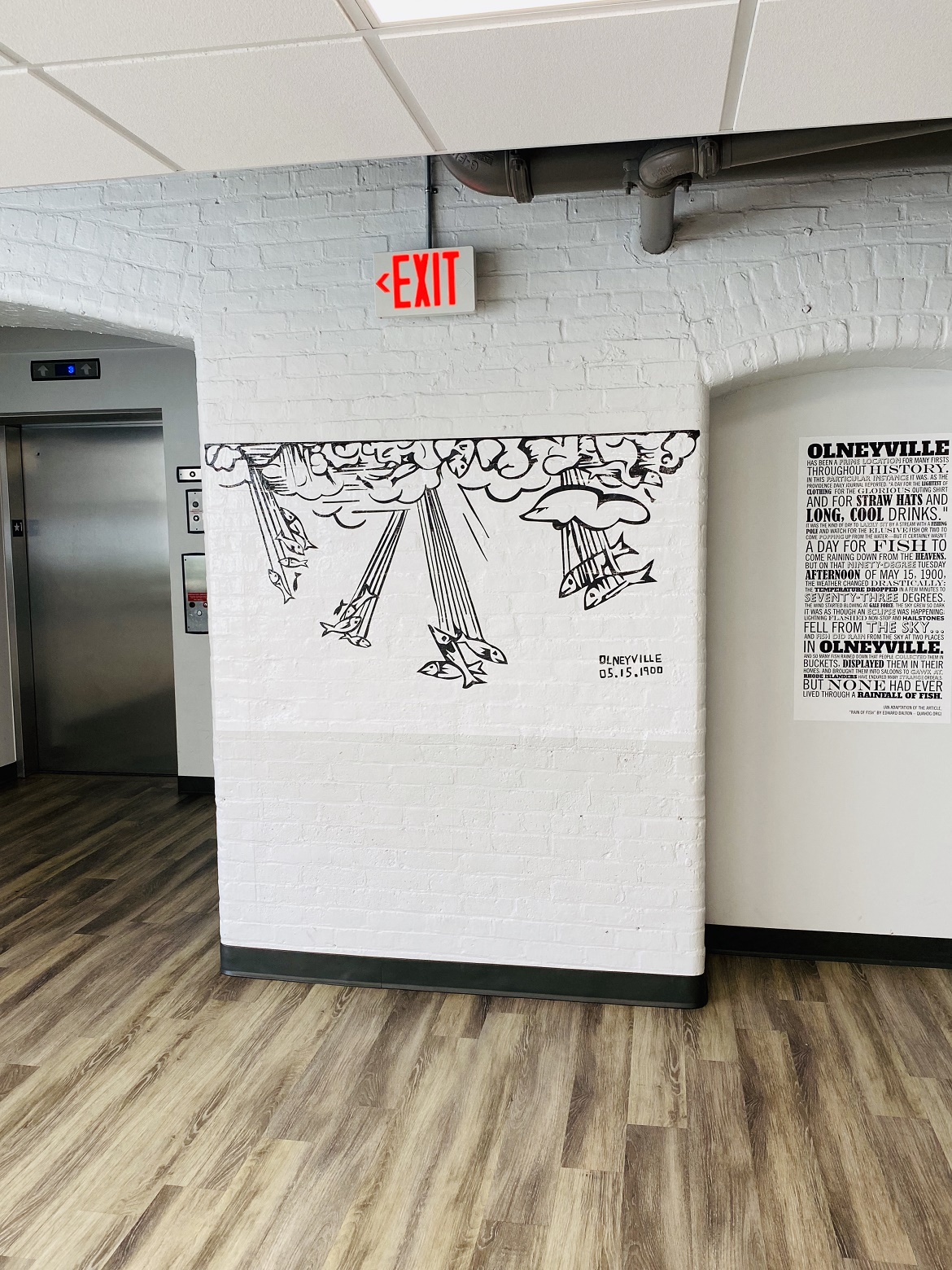 a mural on a wall in a room with an exit door