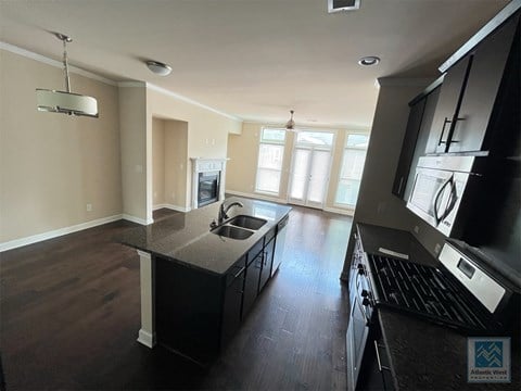 a view of a kitchen with a stove and a sink