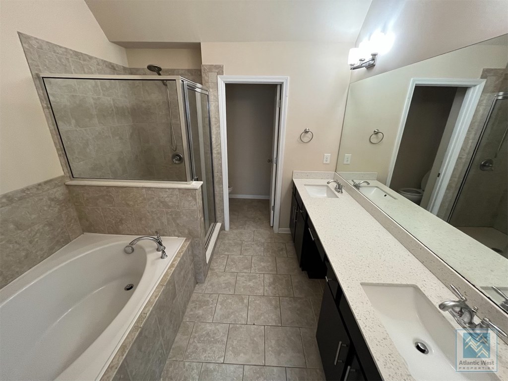 a bathroom with a tub and a sink and a mirror