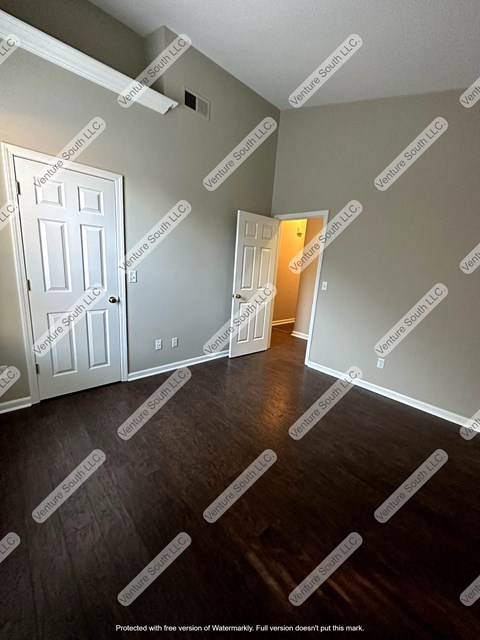 an empty room with a door and a hallway