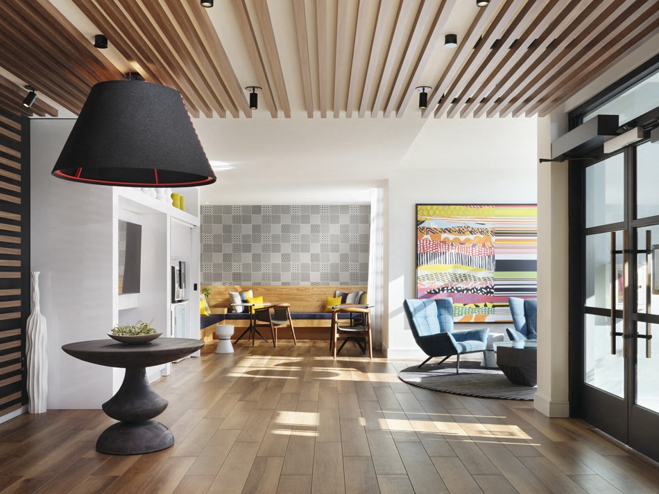 a living room with a large lamp and a table