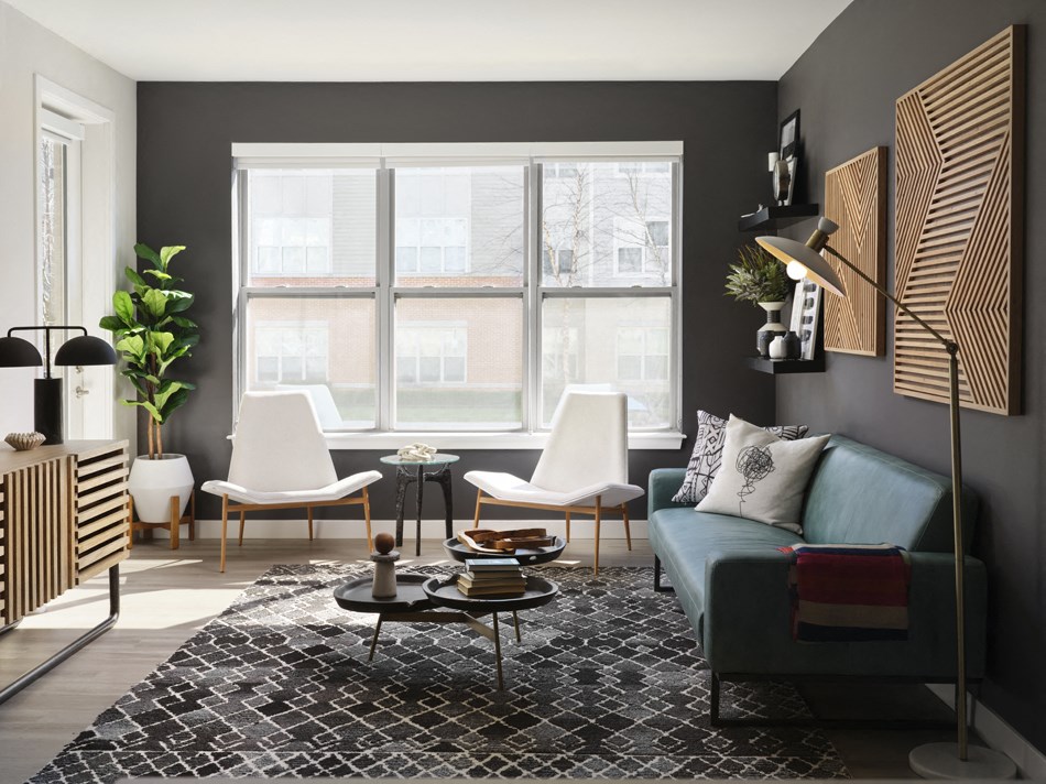 a living room with a blue couch and a large window