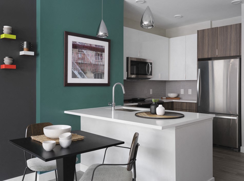 a kitchen with a large island and a table with chairs