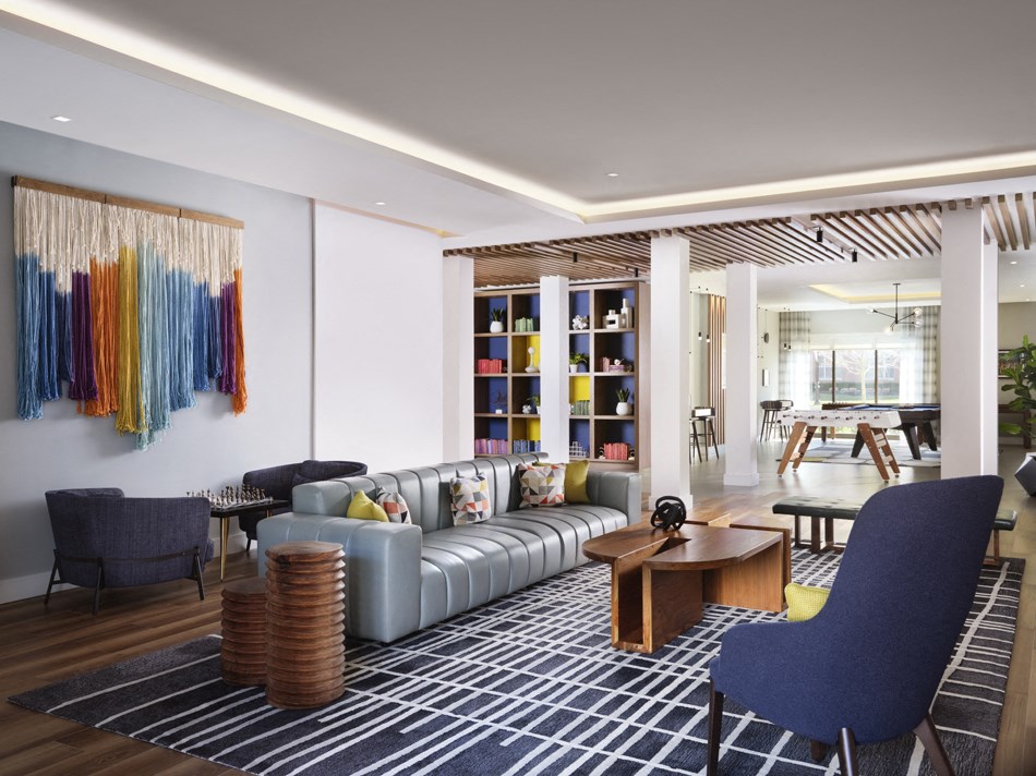 a living room with a couch and chairs and a table