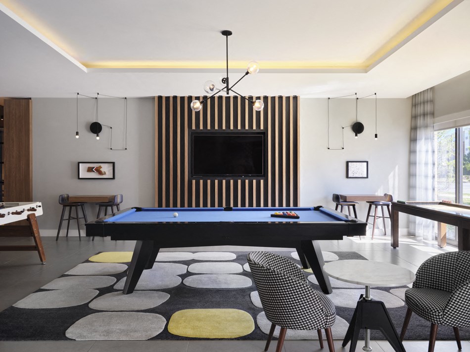 a living room with a pool table and a television