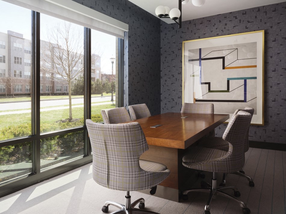 a conference room with a table and chairs and a large window