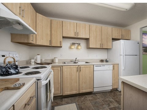 A kitchen with wooden cabinets and white appliances.