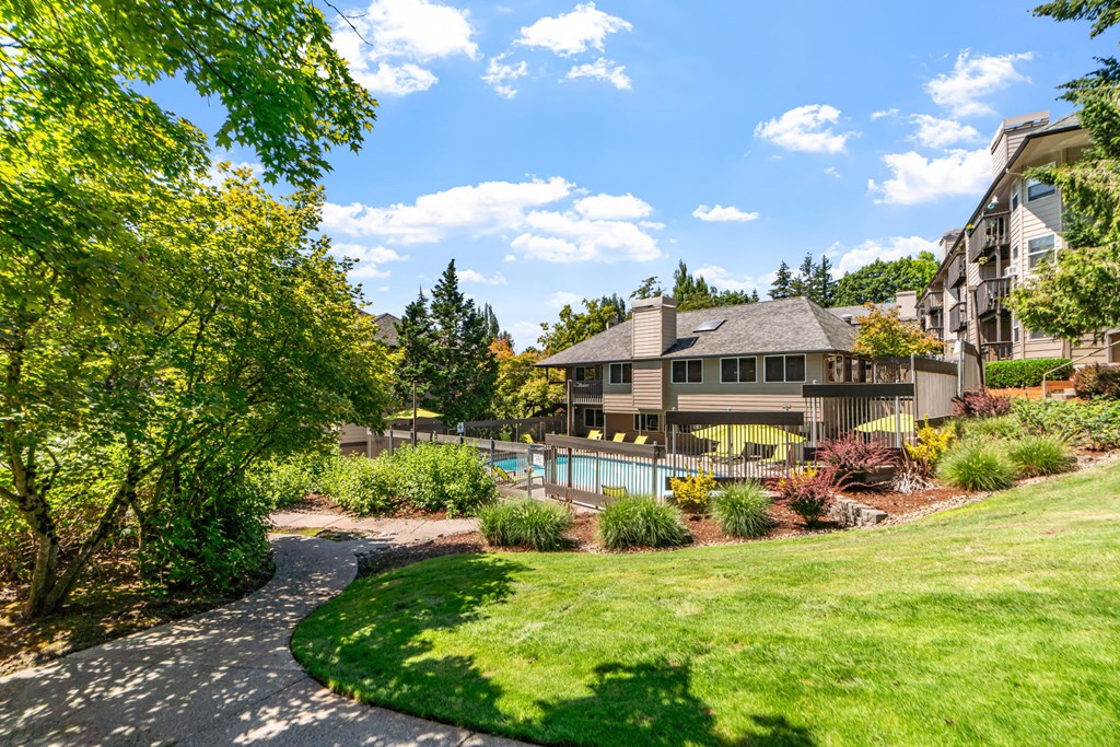 the view of a house with a swimming pool and lawn