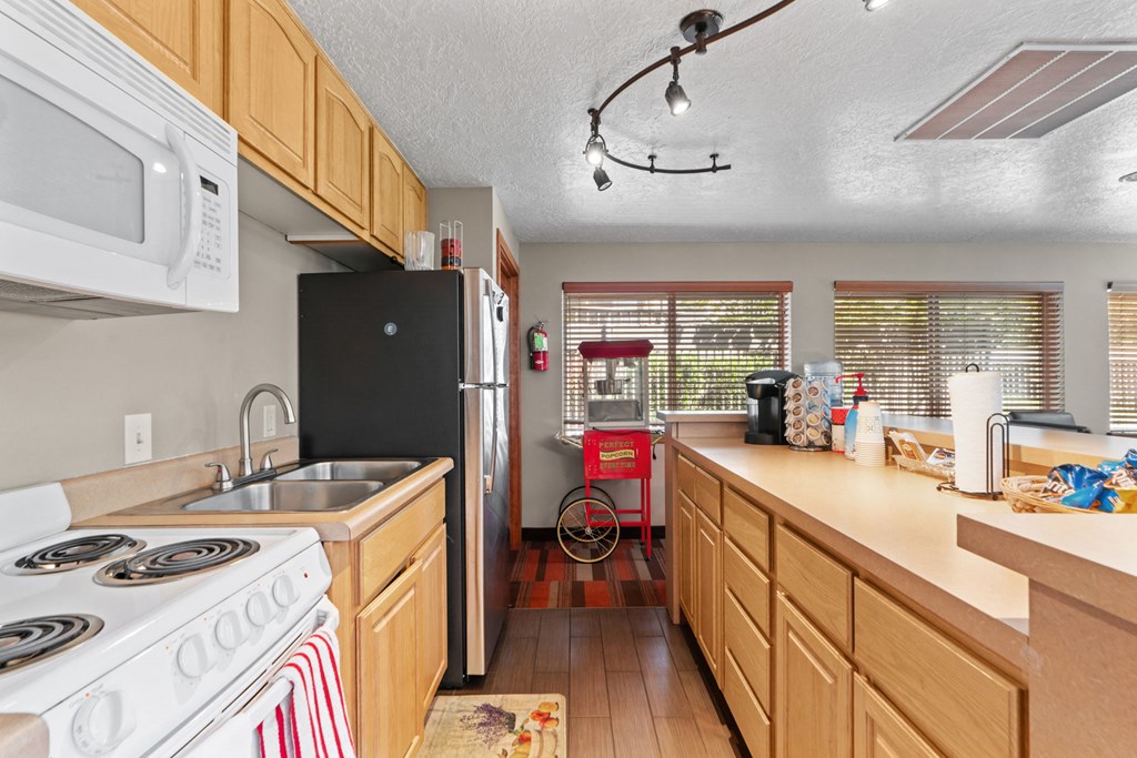 a kitchen with a stove refrigerator and a sink