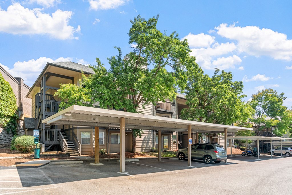 a building with a parking lot and a car parked in front of it