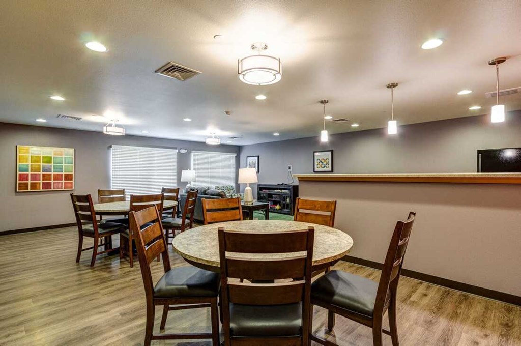 a dining room with a round table and chairs