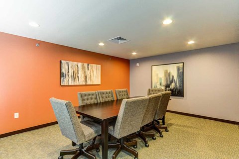 a conference room with a table and chairs