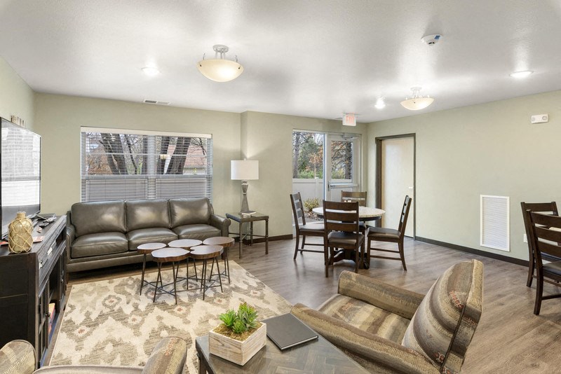 a living room and dining room with couches and a table